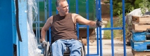 A man in a wheelchair working on a construction site.