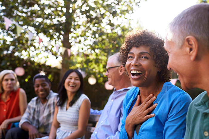 Group of men and woman outside laughing