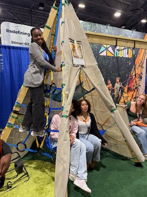 Students climbing structure