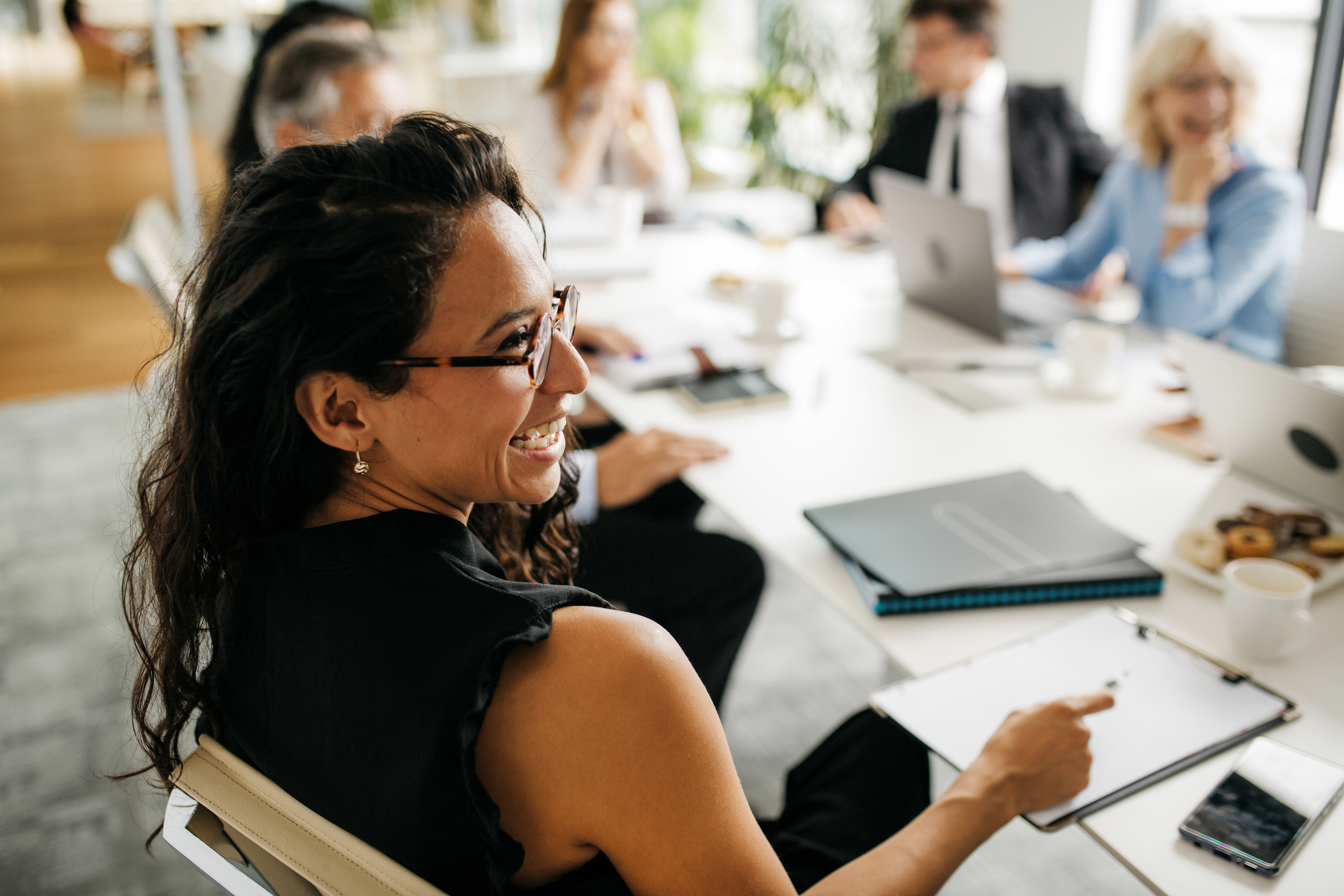 Smiling professional woman at meeting.