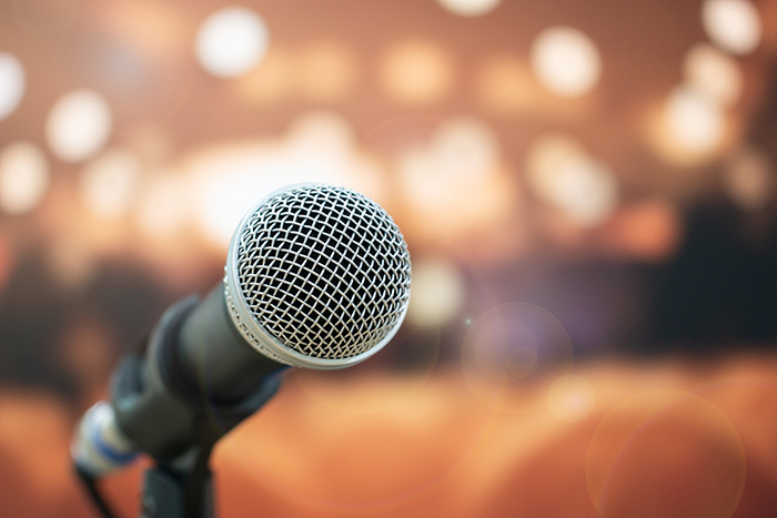 Close up of microphone with blurred lights in background