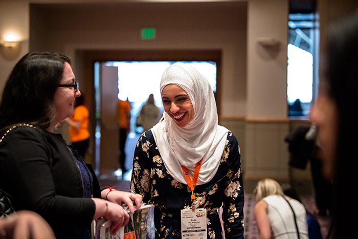 Women talking and smiling at AOTA Annual Conference and Expo