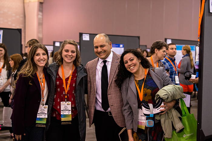 Group of people smiling at AOTA Annual Conference and Expo poster session