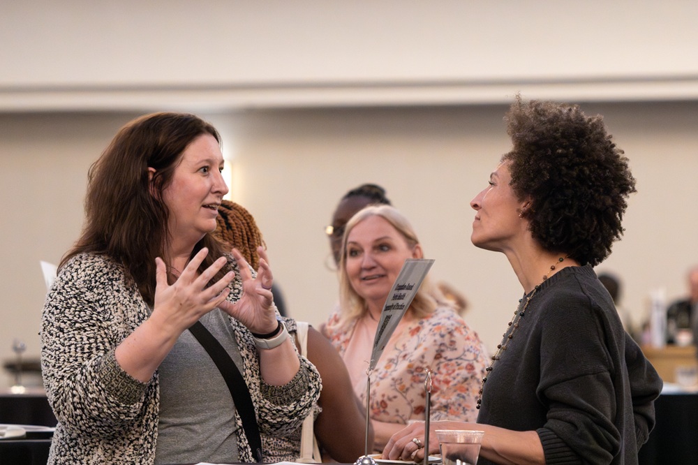 Two people talking at the SIS Networking Reception at AOTA INSPIRE