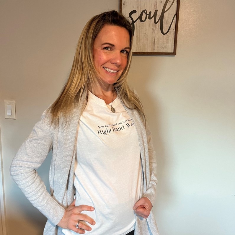 OT Stories - Stroke: K.R., OTR/L grins with hand on hip and the other fisted