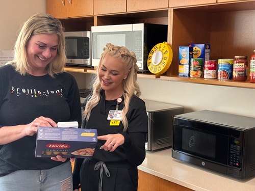 Photo submitted by Teresa Scott shows two women in a kitchen looking at a box of pasta