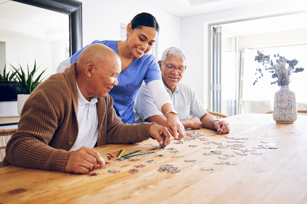 Practitioner works with two older adults on a puzzle