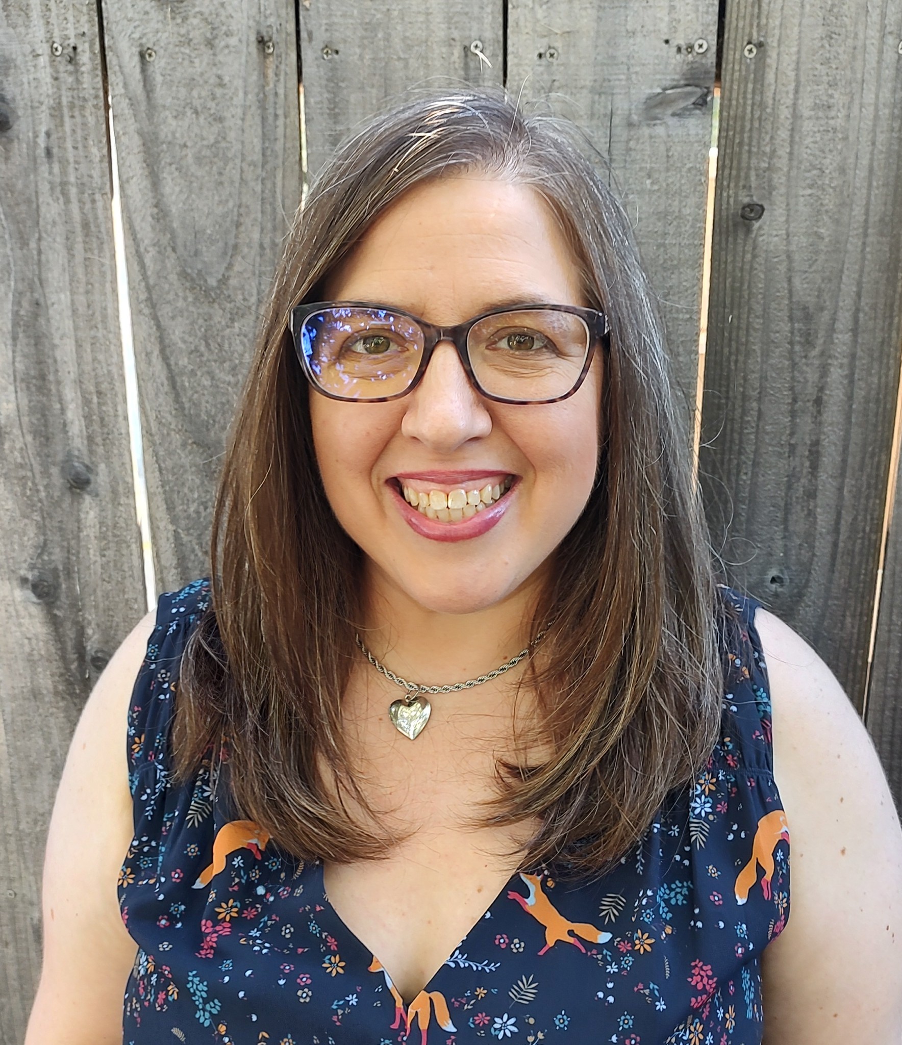 Adrienne Jacobson sitting-blue-top-glasses
