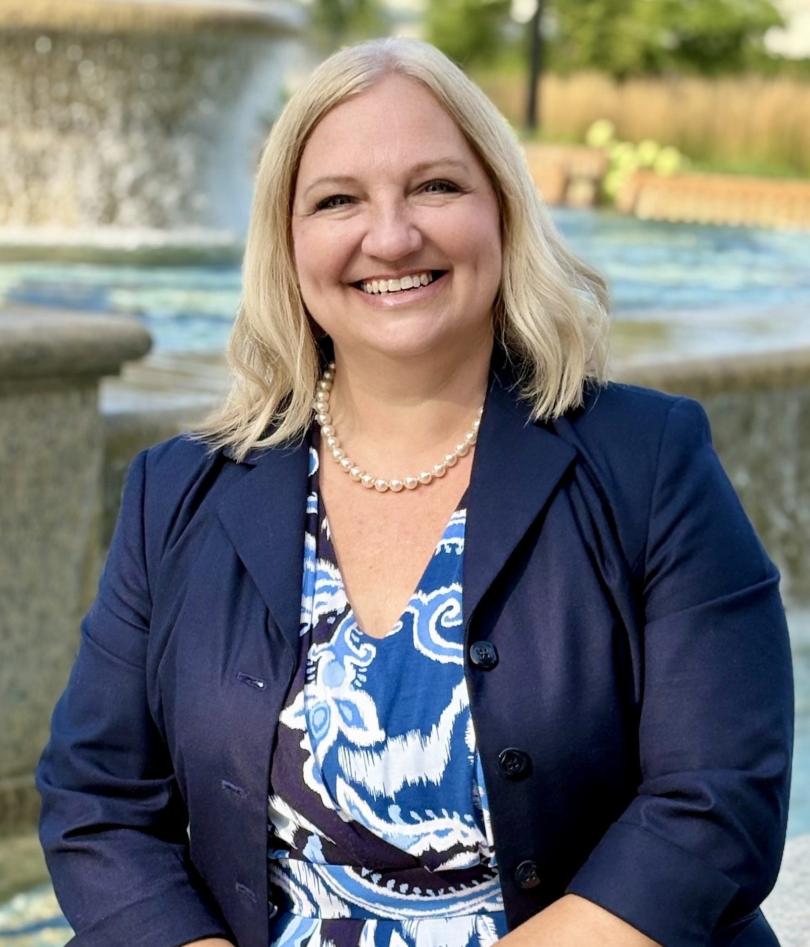 person-smiling-blue-and-white-short-blue-blazer