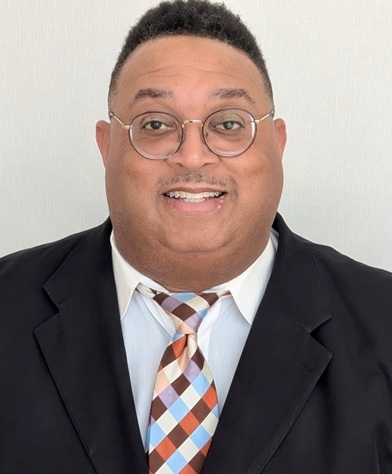 man-smiling-glasses-colorful-tie-black-suit