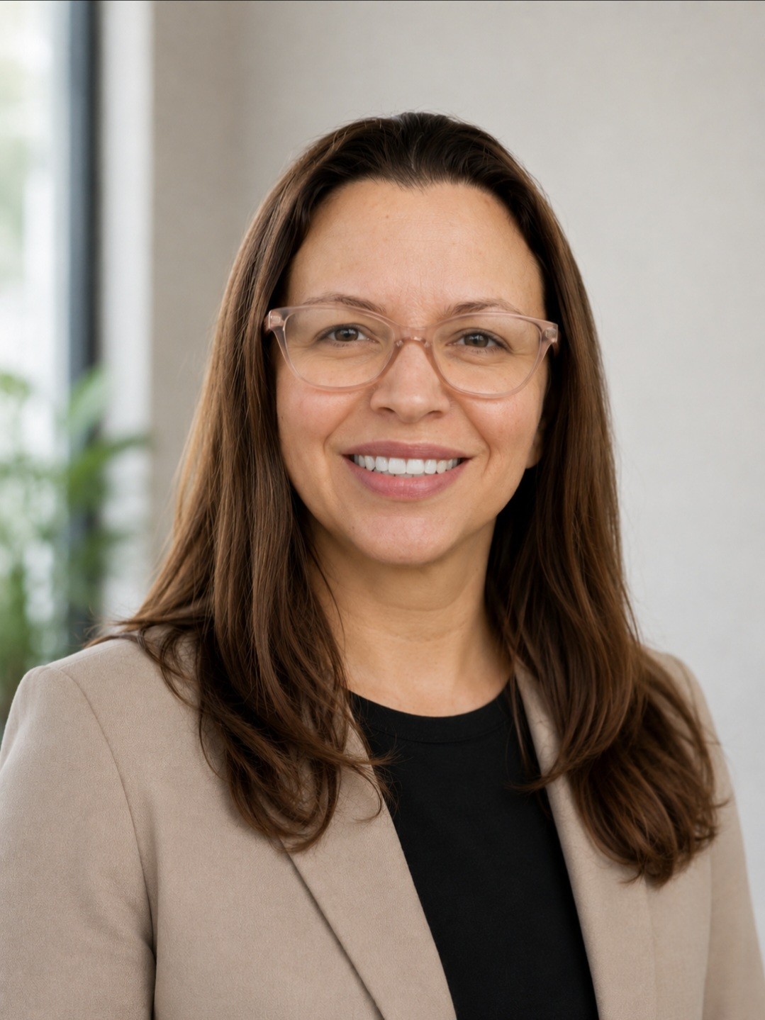 Michelle Mercado sitting-smiling-glasses-tan-jacket