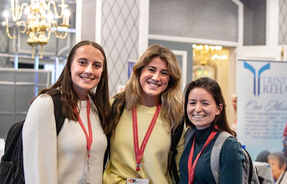Group of three smile for a photo
