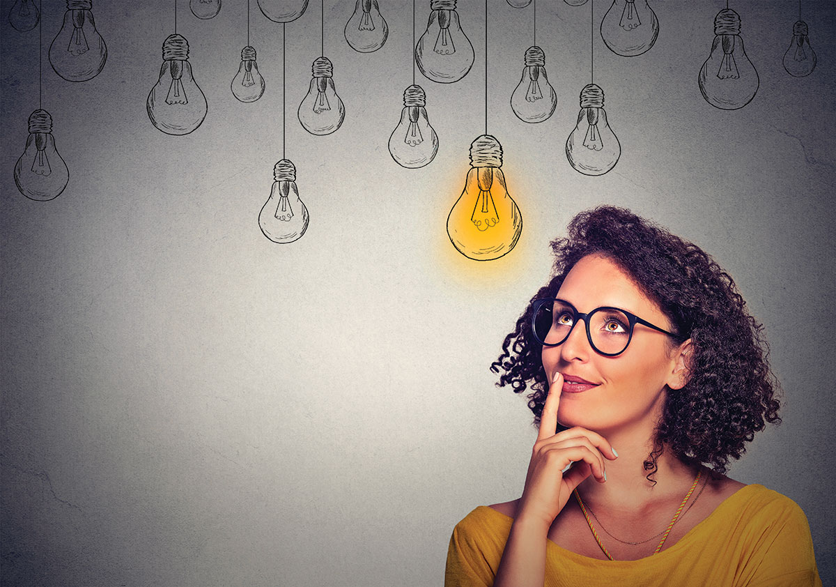 Woman with glasses on and finger on lips looking up to a light bulb illustration