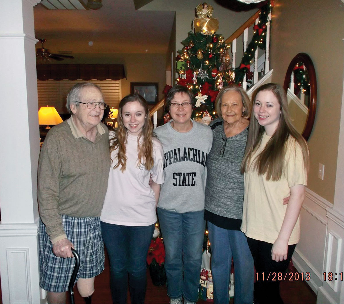 A holiday family photo of McKenzie with her grandparents, mom, and sister.