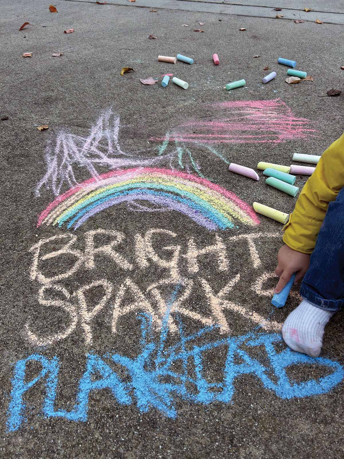 Sensory-rich outdoor environment with a chalk rainbow. 