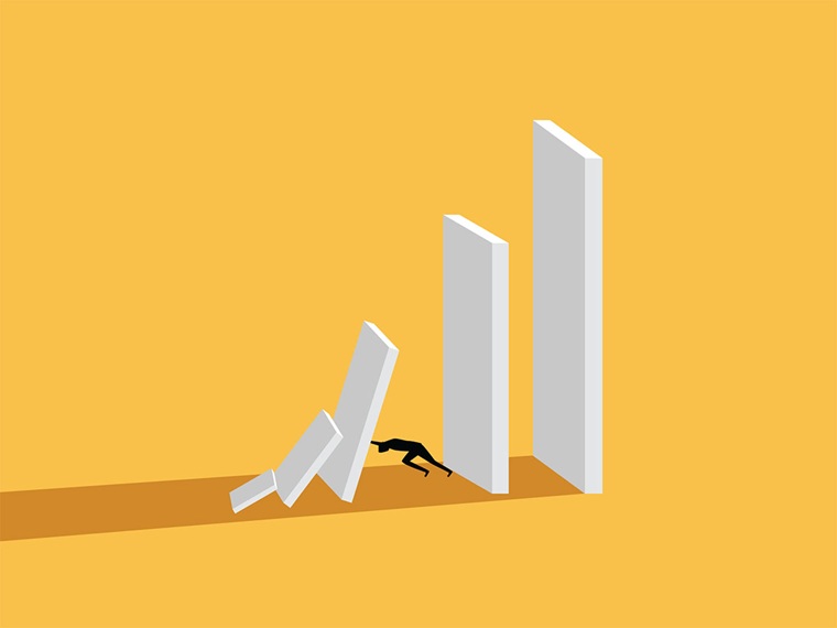 Illustration of person pushing on domino to stop it from falling on him. The dominoes are white on a yellow background.