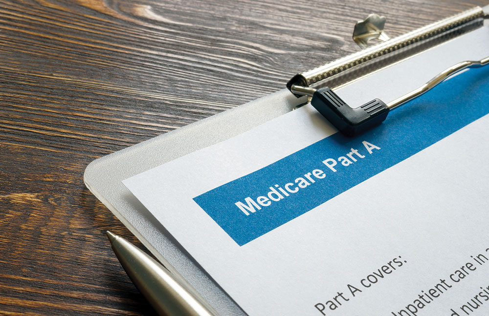 Clip board with a Medicare Part A paper on it and a pen next to it