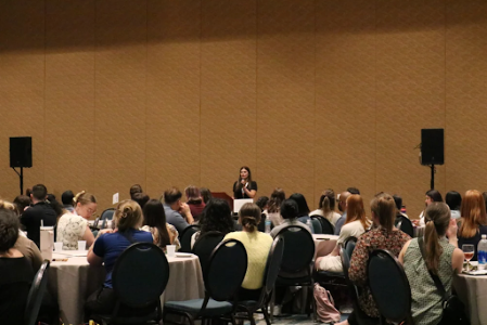 Mya Tschopp speaking to a crowd of ASD Reps at the 2024 ASD Connection Gathering