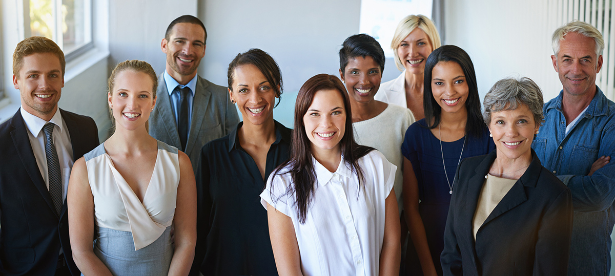 Group of ten diverse professionals posing for camera inside office DEI