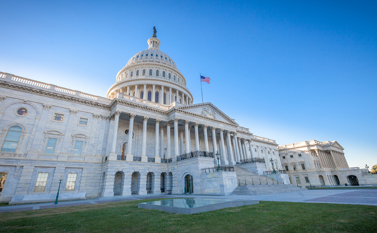 Outside picture of the US Capitol Building against a clear blue sky