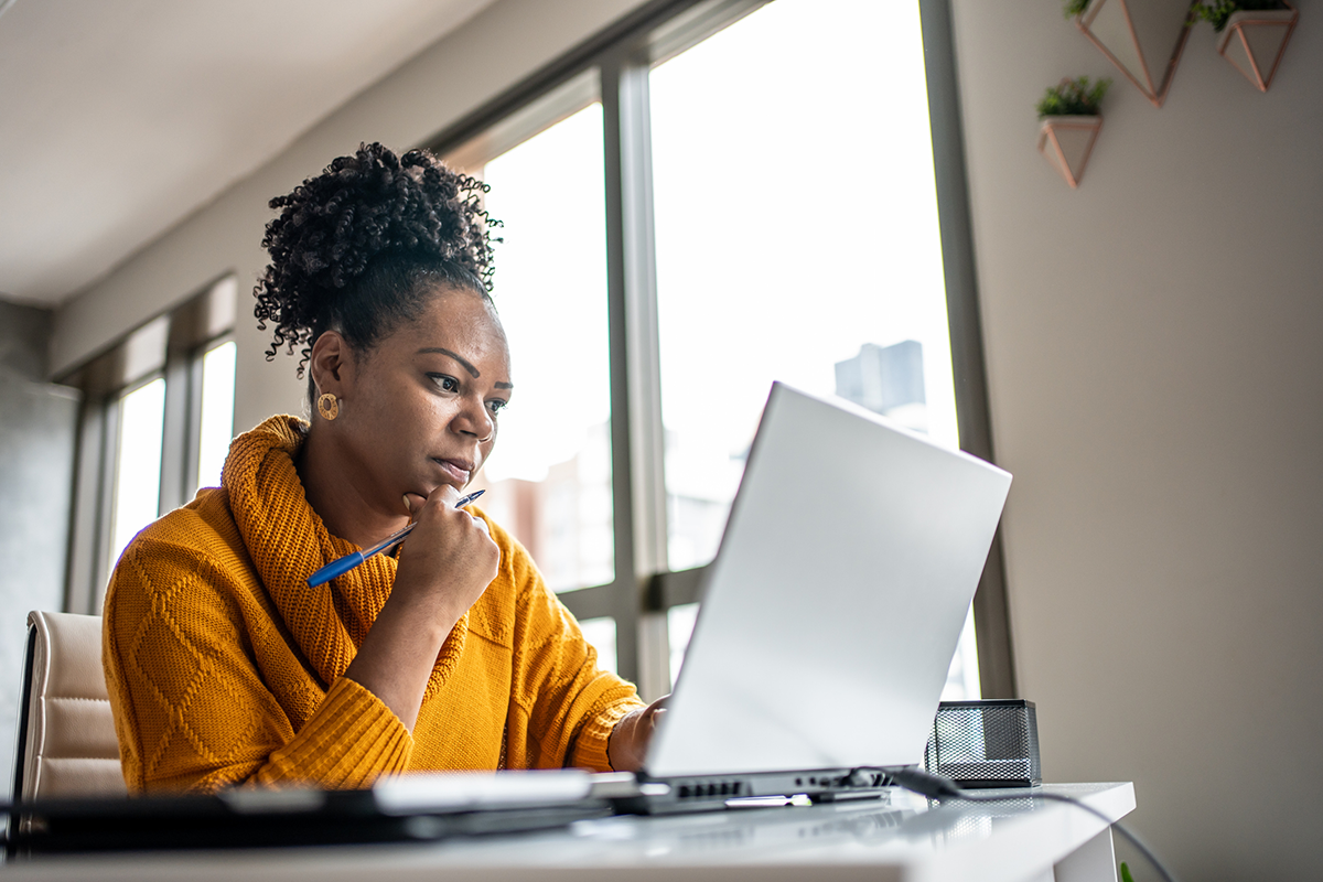 Woman sitting at desk working on laptop