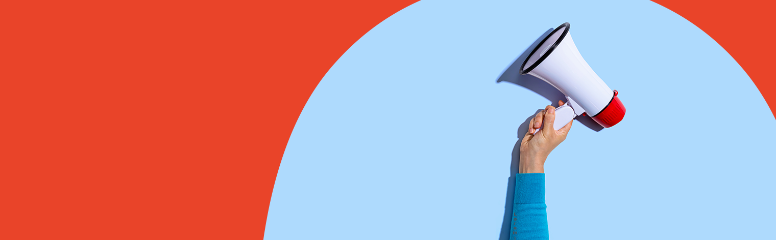 Hand holding a bullhorn