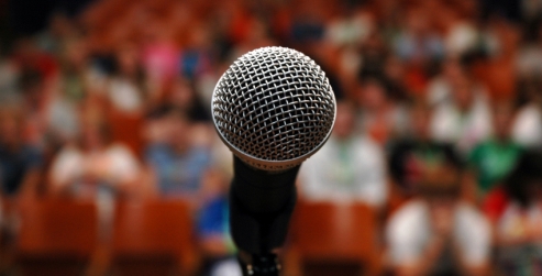 A microphone in front of an audience.