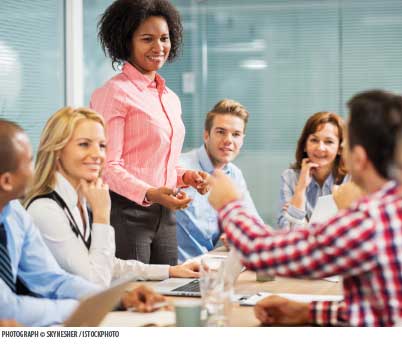 A woman leads a group meeting.