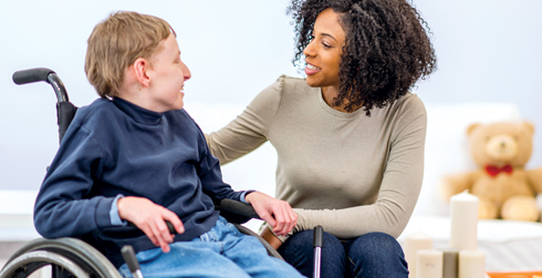 Two people talking; one person is in a wheelchair