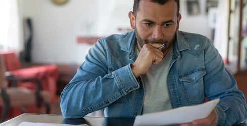 Man studying paperwork at a table
