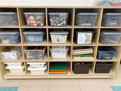 Various containers with objects in an organizational cubby.