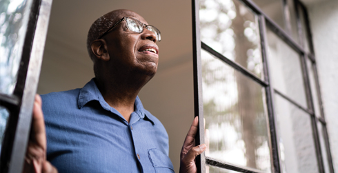 Man looking out window