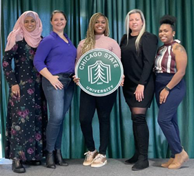 Four students and a teacher holding a University of Chicago sign