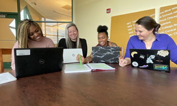 Four students in a writing circle