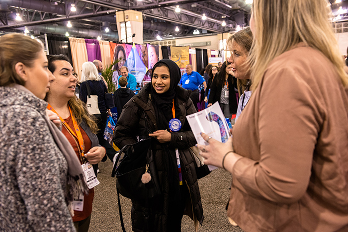 diverse group of women talking at aota annual conference and expo hall