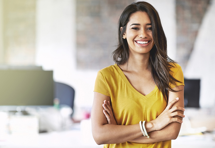 smiling professional woman with arms crossed